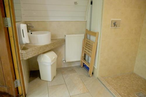 a small bathroom with a sink and a toilet at Camping Pod's in Hanworth