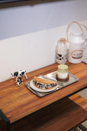 a table with a plate of food and a sandwich on it at Drop Inn Tottori in Tottori