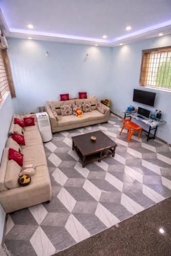 a living room with two couches and a table at Oasis Fun Villa - Pet Friendly Cafe in Indore