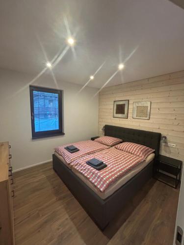 a bedroom with a large bed in a room at Apartmán ESKIMO in Bystrá
