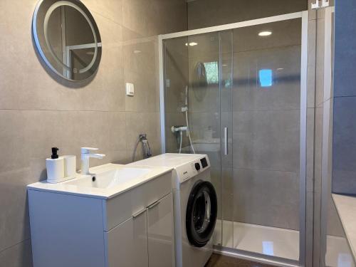 a bathroom with a washing machine and a sink at All You Need Holiday in Pula