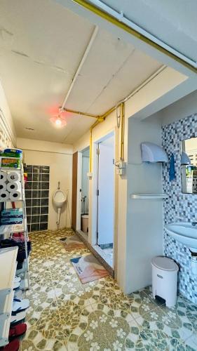 a room with a bathroom with a door and a floor at The Dreamcatcher Hostel Nathon SamuiSunset in Nathon