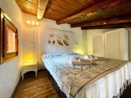 a bedroom with a large bed in a room at Punta Est - Mono TRAMONTANA Soppalco & Sea View in Capo Coda Cavallo