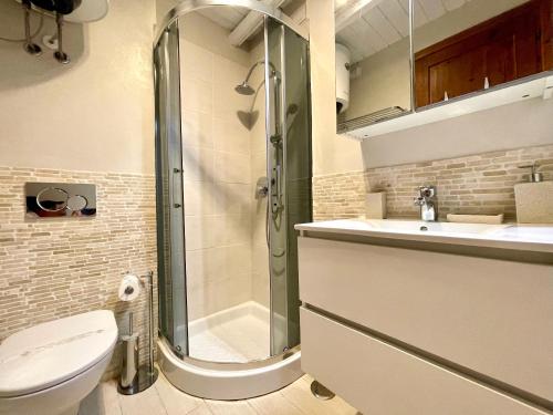 a bathroom with a shower and a toilet and a sink at Punta Est - Mono TRAMONTANA Soppalco & Sea View in Capo Coda Cavallo