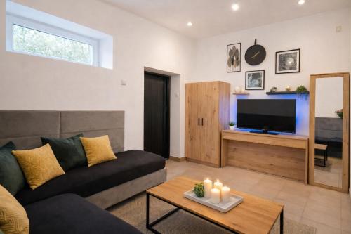a living room with a couch and a tv at Miodowa Zagroda - nocleg Zator Energylandia in Miejsce
