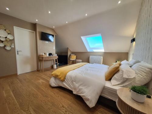 a bedroom with a large bed and a window at Le Garage & Spa Gold in Gondreville