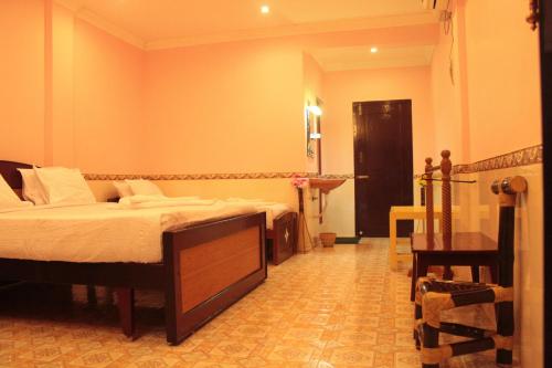a bedroom with two beds and a desk in it at Chettinaadu Narayana Vilas in Kānādukāttān