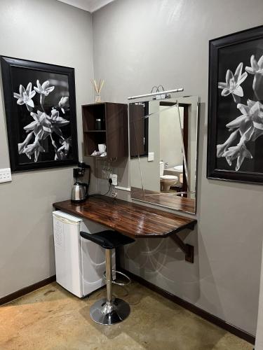 a desk with a mirror in a room at 37 On Anderson in Pretoria