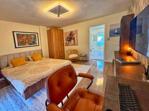 a bedroom with a bed and a desk and a chair at Negotin Centar Apartment with Parking in Negotin