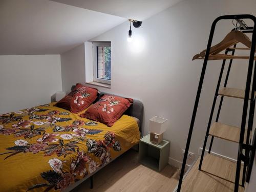 a bedroom with a bed and a ladder in it at Le petit chalet in Mazaye