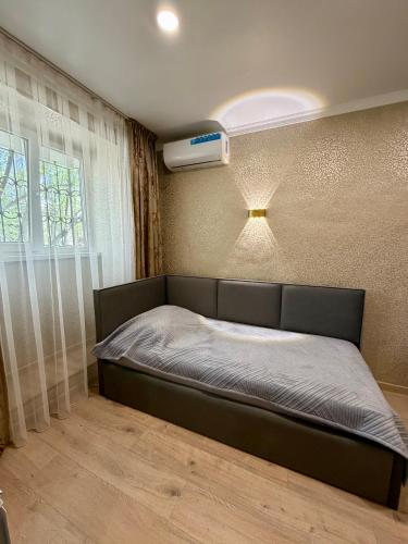 a bed in a room with at Sky 28 in Almaty