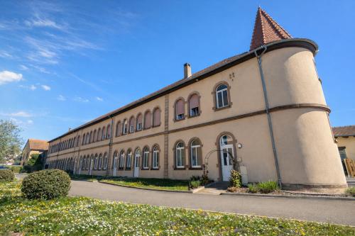 a large brick building with a pointed roof at L'Atelier No 8 in Saverne