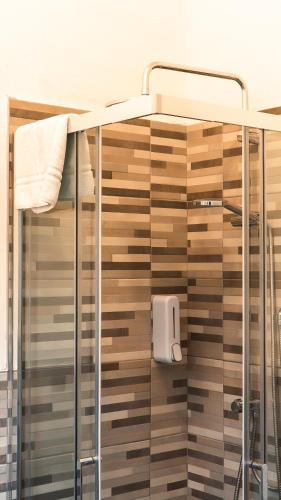 a shower in a bathroom with a glass shower stall at Hotel Fattori in Cesenatico