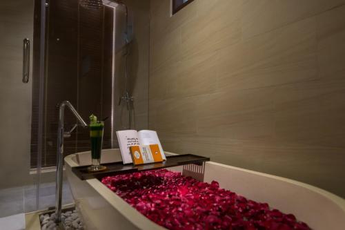 a bathroom with a tub filled with red roses at Ulun Ubud Resort - CHSE Certified in Ubud