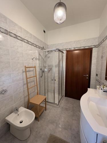 a bathroom with a shower and a toilet and a sink at Civico 107 in Capolona