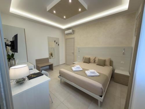 a bedroom with a bed and a room with a bathroom at Cattleya Rooms in Sestu