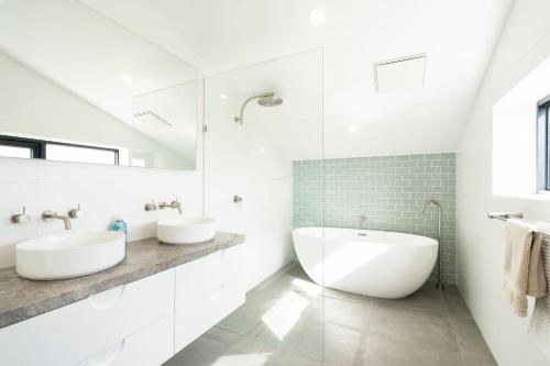 a white bathroom with two sinks and a tub at Connewarre Farm Stay - Sleeps 10 - Acreage By HostyCo in Connewarre