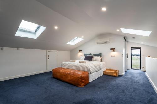 a bedroom with a bed and skylights at Connewarre Farm Stay - Sleeps 10 - Acreage By HostyCo in Connewarre