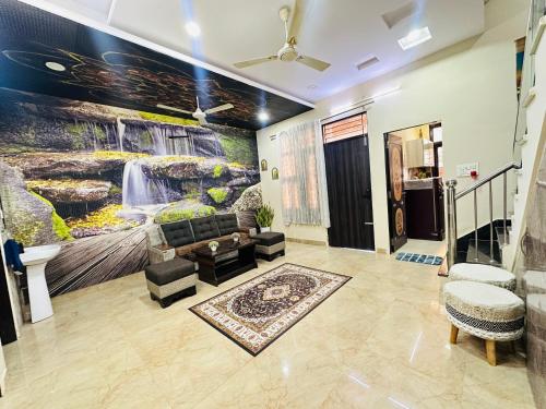 a living room with a large painting on the wall at Nasadra villa in Jaipur