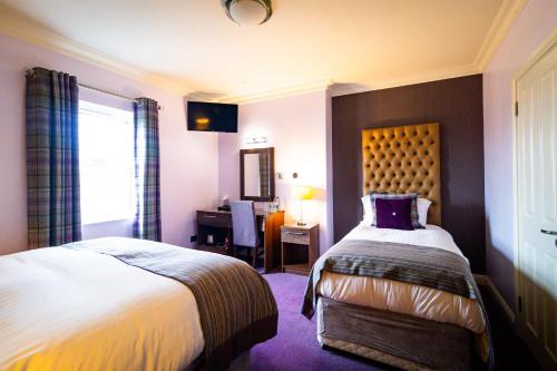 a hotel room with a bed and a desk at Anchorage Inn in Portstewart