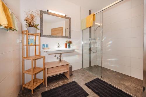 a bathroom with a sink and a shower at Landhaus Gerstgraser in Rauris