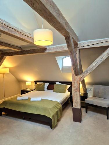 a bedroom with a large bed and a vaulted ceiling at Hirscher Loft in Braşov