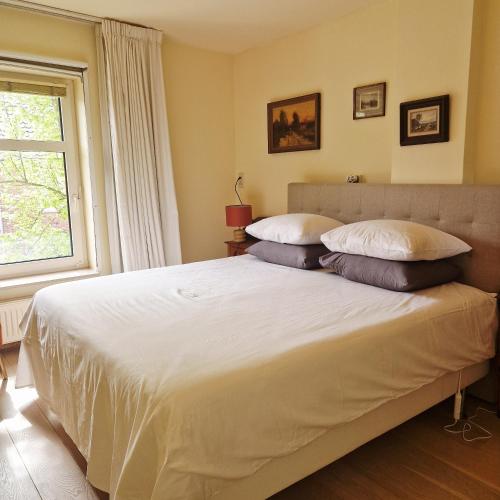 a bedroom with a large white bed with pillows at B&B Chez Paz in Neer