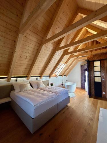 a large bedroom with a bed and a bath tub at Living & Relax Resorts in Sausal