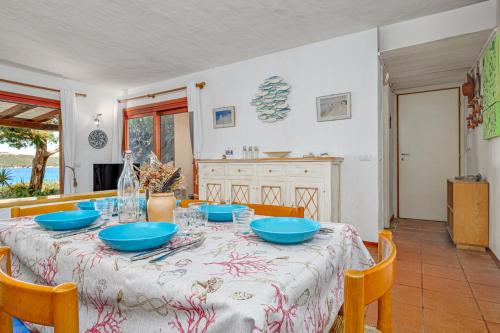 a dining room with a table with blue bowls on it at Marana Orizzonte in Santa Marinella