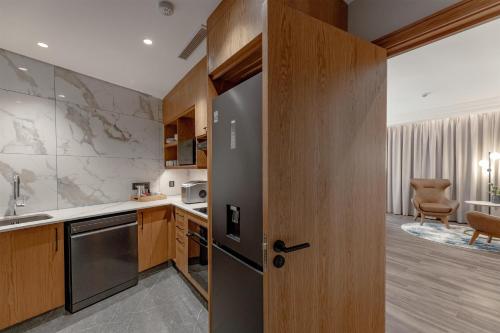 a kitchen with a door leading to a living room at Radisson Blu Hotel Lusaka in Lusaka