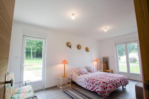 a bedroom with a bed and a window at Le repere in Tocane-Saint-Apre