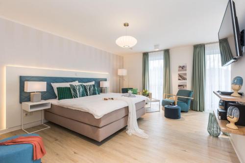 a bedroom with a large bed with a blue headboard at Am Park 27 in Prerow