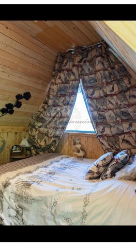 a large bed in a room with a rock wall at la marmotte in Granges-Aumontzey