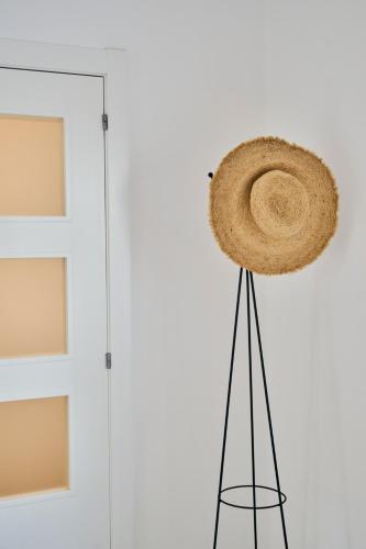 a straw hat on a pole next to a door at CASA CALMA Blanes in Blanes