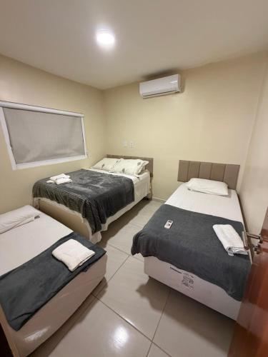 a room with two beds in a room at aconchegoreceptivo in Marechal Deodoro