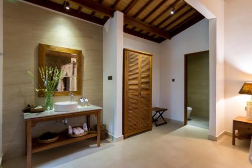 a bathroom with a sink and a mirror at Ulun Ubud Resort - CHSE Certified in Ubud