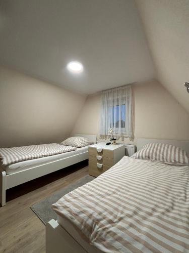 a bedroom with two beds and a window at fewo-brigitte in Buxtehude