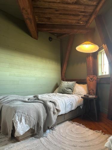 a bedroom with a bed and a lamp in a room at Windmill with the best sunset view in Borgholm