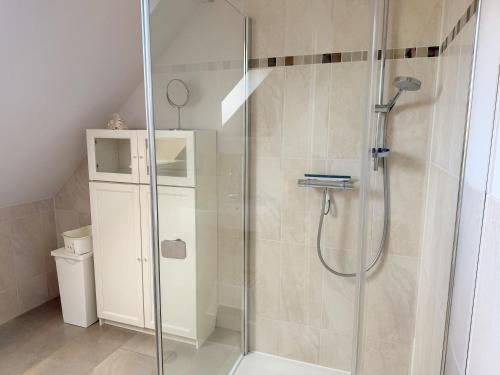 a shower with a glass door in a bathroom at 1320 - "Haus Maria" in Dahme