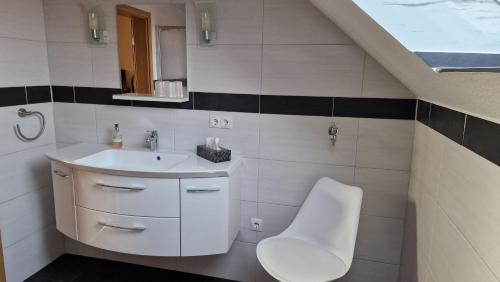 a bathroom with a sink and a toilet at ferienwohnung mertens in Westerstede