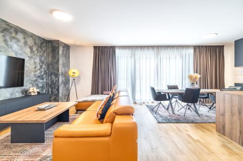 a living room with a couch and a table at Arena Lux Apartments in Zagreb