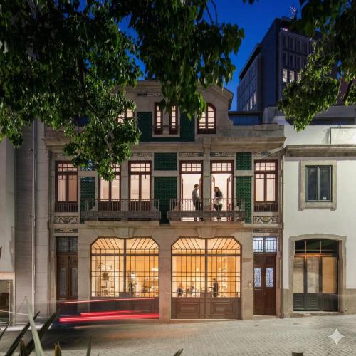 a building with a balcony with people on it at Trindade Premium Apartments in Porto