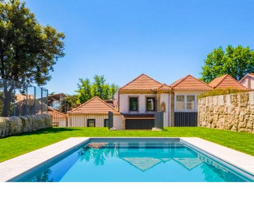 a house with a swimming pool in a yard at Terrace Pool Apartment Oporto by LovelyStay in Porto