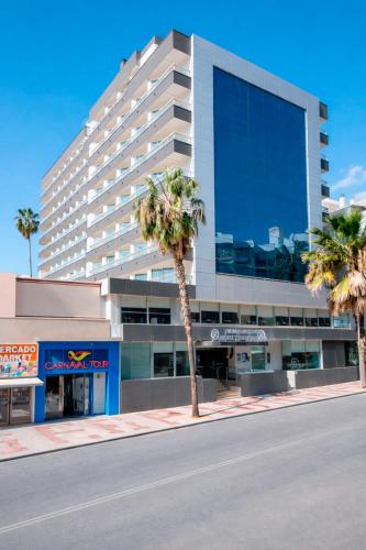 a large building with palm trees in front of it at Hotel Costa Málaga - Adults Recommended - by Pierre & Vacances in Torremolinos