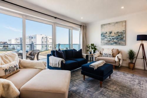 a living room filled with furniture and a large window at Sea View 3 bedroom seaside property in Chichester