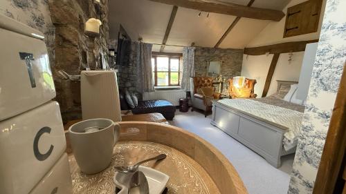 a bathroom with a sink and a bed in a room at The Stables Inn in Minsterley