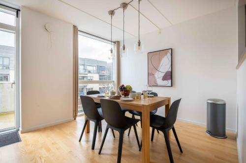 a dining room with a wooden table and chairs at Amazing Two Bedroom Apartment in Urban Area in Copenhagen
