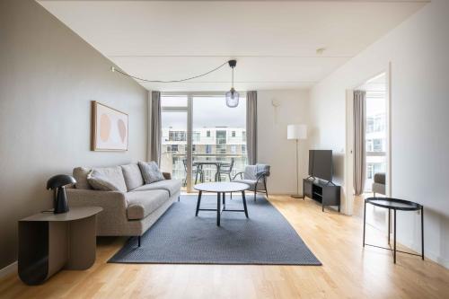 a living room with a couch and a table at Amazing Two Bedroom Apartment in Urban Area in Copenhagen