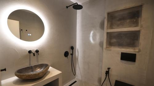 a bathroom with a sink and a mirror at Sani Chateau in Sani Beach