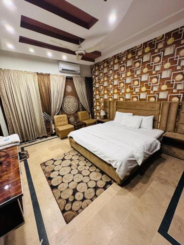 a bedroom with a bed and a couch and a table at MadCrew GuestHouse in Islamabad